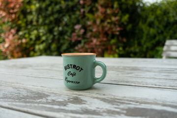 vintage cup of coffee on a white old wooden table in the garden