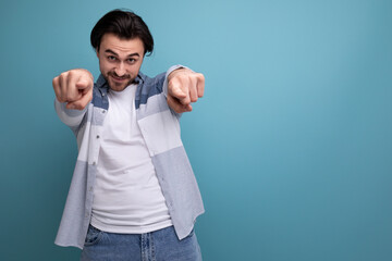 Fototapeta premium successful lucky young brutal brunette guy on a studio background