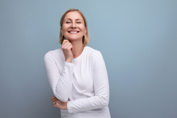 happy healthy blonde middle aged woman in white sweater in premenopausal phase