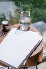 Magazine and book mockup design. Blank magazine on modern wooden table with candles , shadow overlay