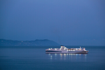 Passenger pax cargo car roro ro-ro ferry boat vessel cruiseship cruise ship liner at sea with blue...
