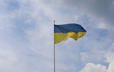 Ukrainian flag on blue sky. Country flag against sky. Flags of the world. Peace in the world. Peaceful flag.