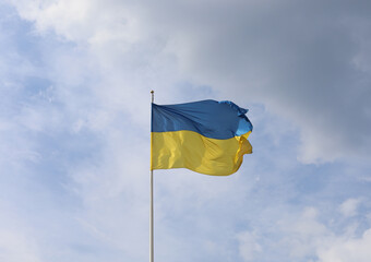 Ukrainian flag on blue sky. Country flag against sky. Flags of the world. Peace in the world. Peaceful flag.