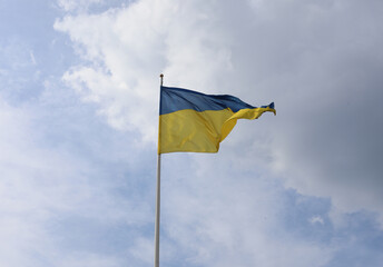 Ukrainian flag on blue sky. Country flag against sky. Flags of the world. Peace in the world. Peaceful flag.