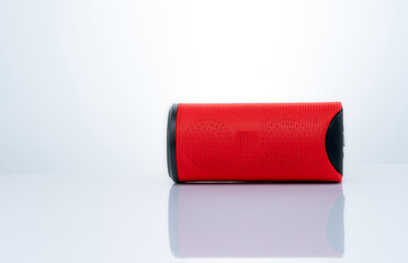 Wireless portable speaker isolated on white background. Red Digital portable speakers. Small sound music box speaker. Modern design mini portable Wireless loudspeaker. Digital wireless technology.