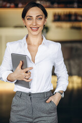 Business woman holding tablet in a cafe