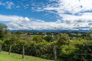 Fototapeta na wymiar Panoramic view of the Tweed Valley, from Tweed Regional Valley, with mountains of Lamington National Park and Springbrook Plateau on the horizon. Murwillumbah, New South Wales, Australia