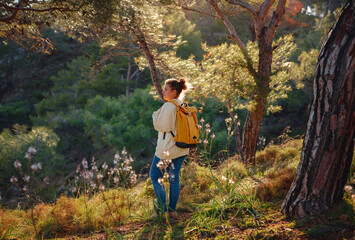 Travel and active lifestyle concept. Happy smiling woman hiking in mountains , Fethie, Turkey. Young female hiker smiling, sport and trekking in autumn or spring nature.
