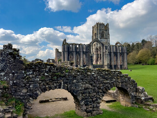Ruins of Fountains Abbey near Ripon in North Yorkshire in the northeast of England. Founded in 1132, the abbey operated for 407 years, becoming one of the wealthiest monasteries in England.