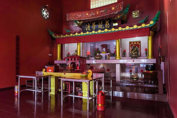 Interior view of red temple or shrine with Chinese buildings theme with reliefs of gods and goddesses, a place of worship for Buddhists in Tarempa, Anambas Islands, Riau Archipelago, Indonesia.