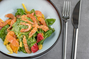 Salmon salad on stone table in fine dining restaurant