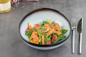 Salmon salad on stone table in fine dining restaurant