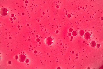 Bubble pink background texture. Berry gel to cleanse the skin of the face and body. Spa treatments, skin care. Bath foam, detergent. Slime pink.