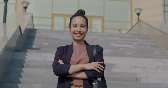 Slow motion portrait of successful young businesswoman standing next to modern office center smiling looking at camera. People and urban lifestyle concept. Generative AI