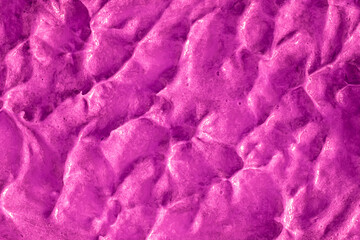 Smears of liquid purple magenta gel texture background. Smeared oil paint with pearly shine. Cream...