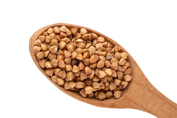 Raw buckwheat in a wooden spoon isolated on white background, macro, top view.