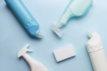 Flatly cleaning products on a blue background. Sponge and cleaning spray. bottle cleaning mockup