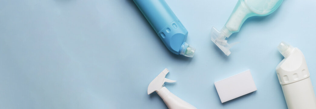 Bsnner flatly cleaning products on a blue background. Sponge and cleaning spray. bottle cleaning mockup
