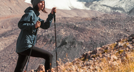 Girl is climbing in the mountains. © Zhanna