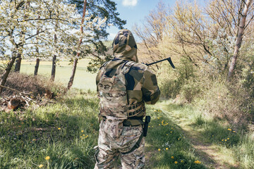 Ukrainian soldier on the front line. With an assault rifle in camouflage..