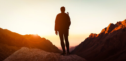 Man is climbing, hiking in the mountains.