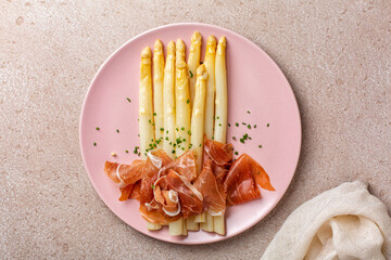 Cooked white asparagus with crudo prosciutto or  ham, spring onion and butter dressing. The Spruce...