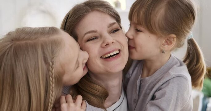 Slow motion shot of caucasian beautiful woman laughing cheerfully while cute daughters embracing and kissing her on cheeks at home Generative AI