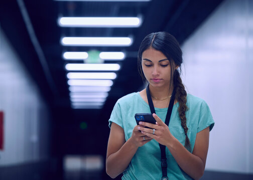 Female technician looking at smart phone
