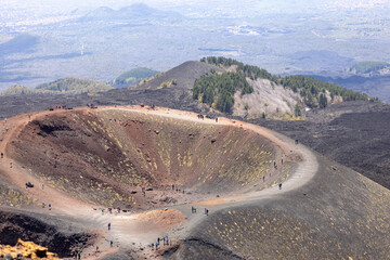 People walking above the Crater Silvestri on the slope of volcano Mount Etna, Sicily, Italy