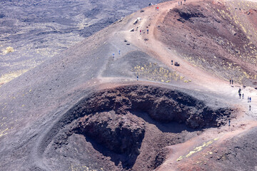 People walking above the Crater Silvestri on the slope of volcano Mount Etna, Sicily, Italy