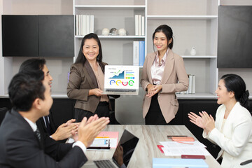 Collaborative process of professional businesspeople using computer and going over on meeting presentation with growth analysis, charts, statistics and data at office meeting concept.