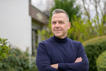 Middle-aged man with gray hair in the garden