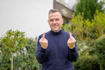 Middle-aged man with gray hair in the garden