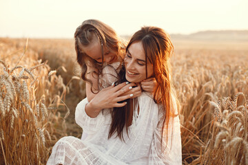 Mother with daughter playing in a summer field