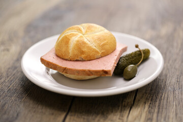 Leberkässemmel is a Kaiser roll sandwich with Leberkäse meatloaf in between.