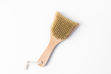 Wooden massage brush isolated on a white background. The concept of health care and body care
