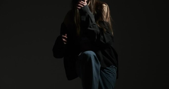 Active woman in sports bra and unbuttoned shirt dancing in hip hop style Generative AI