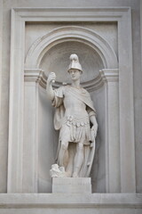a depiction of a medieval soldier with broken lance and uniform as a sculpture in Venice Italy
