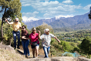 Happy senior couples having fun while moving up the mountain.