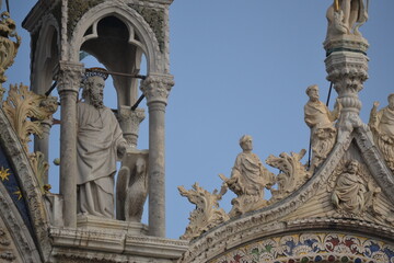 Fototapeta na wymiar an adornment of a building with copious human possibly sacred sculptures in Venice Italy