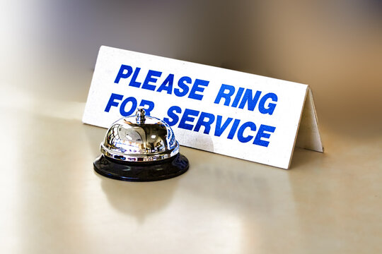 Please ring for service sign and service bell on a desk. Photography