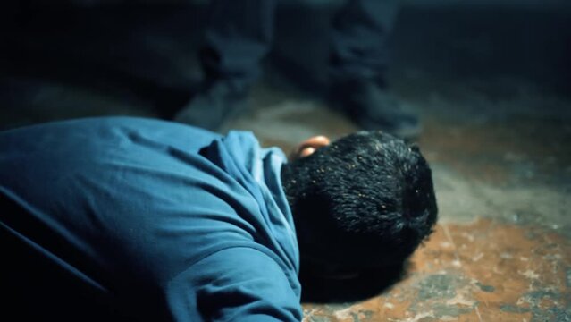 Over the top shot of an injured man lying on the ground, cinematic lighting Hd footage. Easy to use.