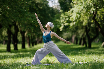 Young woman doing yoga exercise outdoor in the park, sport yoga concept