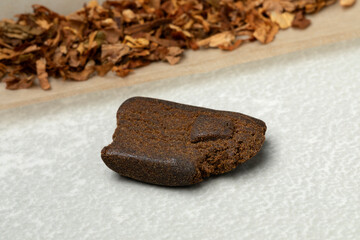 Ingredients for a joint with a piece of afghan hash isolated on white background close up    