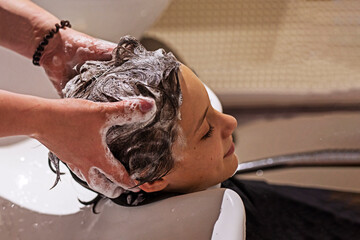 barbershop washing boy's head before haircut