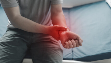 Close up man suffering from wrist pain.