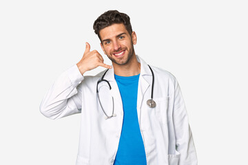 Young doctor man showing a mobile phone call gesture with fingers.