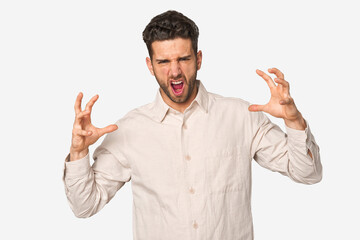 Naklejka premium Young handsome man isolated screaming with rage.