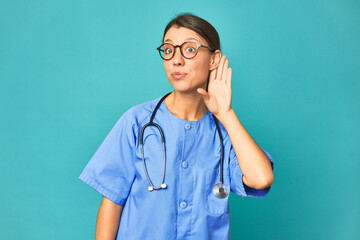 A young nurse woman isolated trying to listening a gossip.