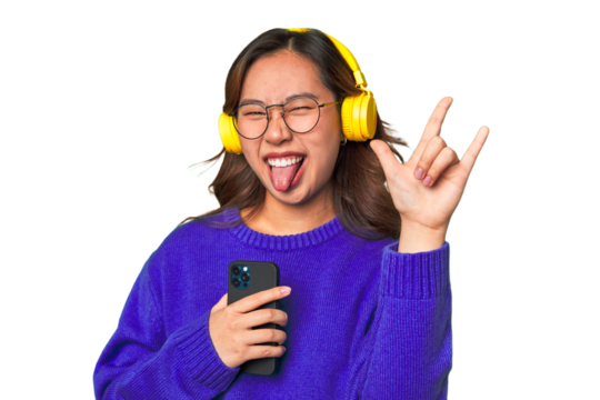 Joyful Asian woman wearing headphones, enjoying music and having fun